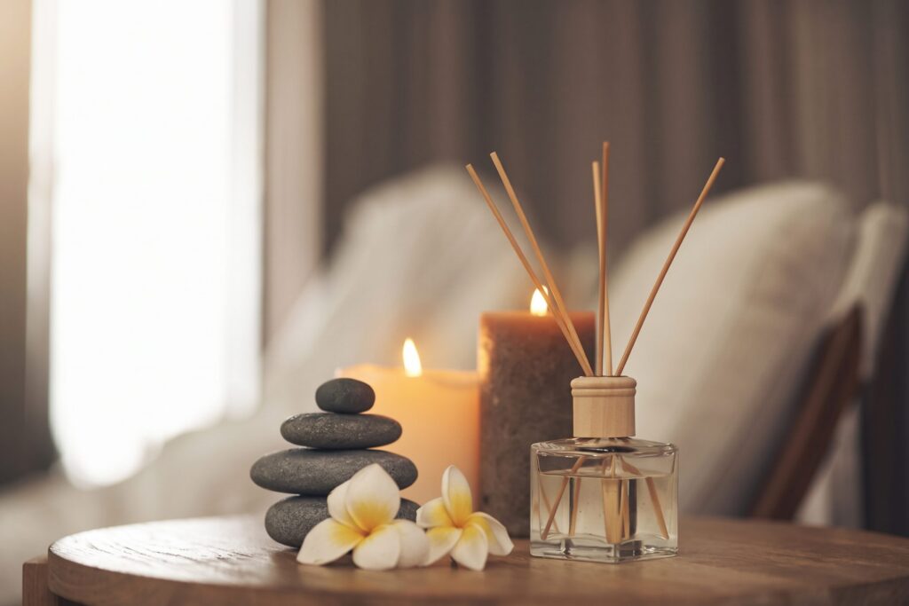 Spa candles, stacked stones, frangipani flowers and a reed diffuser